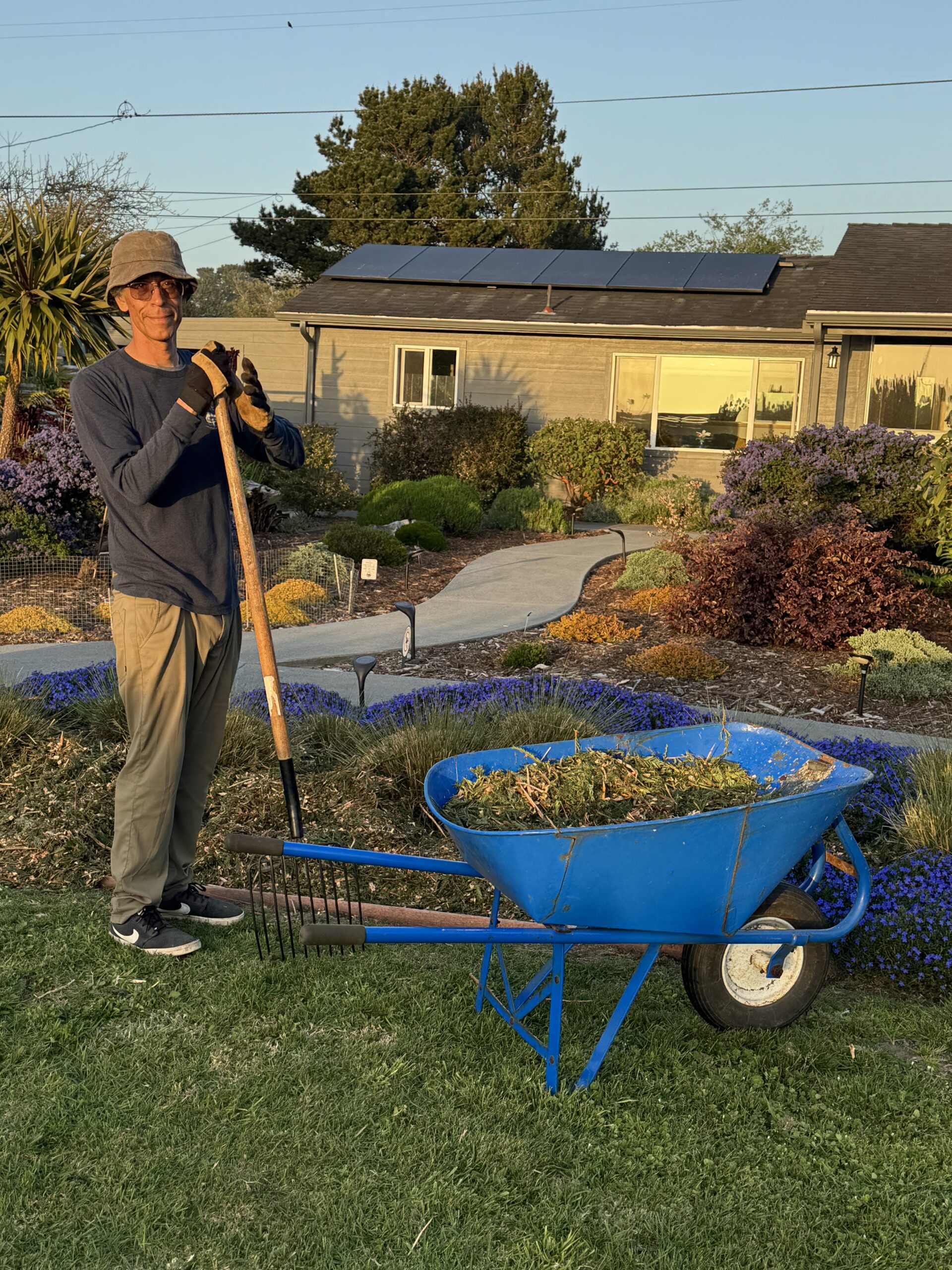 IMG_2013 man working with a wheelbarrow in his yard